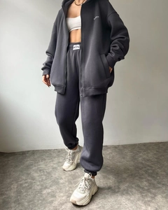 Detail of dark grey fleece tracksuit with Madmos logo and high-quality cotton texture