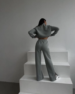 Sage green loungewear set featuring cropped sweatshirt and wide-leg trousers with side slits