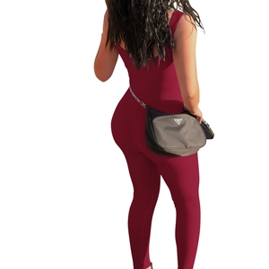 Detail of the open back and ribbed texture on the wine red sleeveless sports jumpsuit