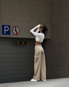 Detail of khaki wide-leg cargo pants with pockets and white slim crop top street style
