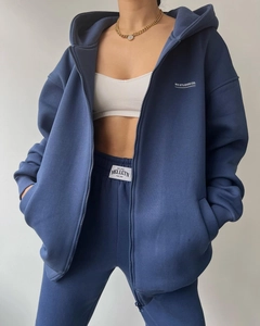 Detail of navy blue hooded tracksuit with zip hoodie and matching joggers on model