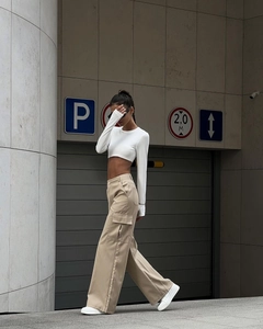 Detail view of high waist khaki cargo trousers with large flap side pockets for women