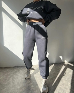 Detailed view of the dark grey tracksuit showing the premium cotton fabric and print