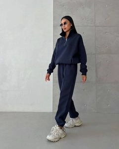 Close-up of navy blue oversized half-zip sweatshirt and jogger pants tracksuit set