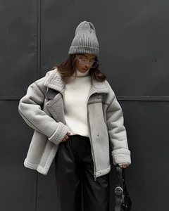 Detail of grey shearling jacket collar and sleeve textures with minimalist street style