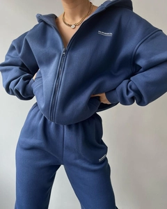 Detailed texture of heavy cotton fabric on navy blue zip hoodie and joggers set
