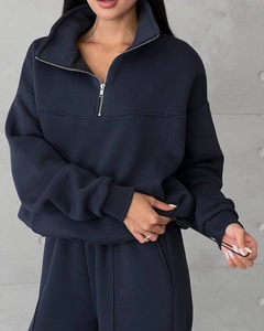 Detail view of navy blue sweatshirt showing adjustable drawstring hem and thick fabric texture