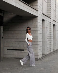 Street style view of high waisted wide leg cargo pants with side pockets in grey color