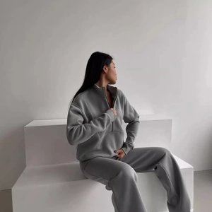 Women's chic grey two-piece tracksuit set with half-zip sweatshirt and wide-leg sweatpants