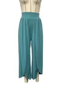 Detail showing high-waist yoga pants with overlapping petal-cut curved leg design in teal