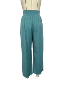 Detail of high waisted teal wide leg trousers with elastic waistband on mannequin