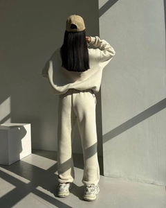 Rear view of cream lounge set featuring oversized sweatshirt and jogger pants with shadows