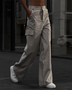 Detail view showing wide-leg light gray high-waisted cargo pants with side flap pockets