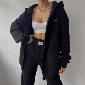 Women's black lounge set featuring hooded sweatshirt and matching joggers with branding