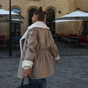 Détail de la veste en suédine avec col en sherpa et cordon de serrage à la taille