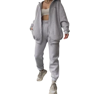 Grey two-piece fleece tracksuit set with hoodie and joggers featuring waist lettering