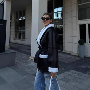 Women's black faux leather shearling jacket with white fur trim and waist belt