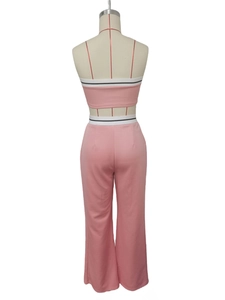 Back view of pink two-piece set featuring wide-leg pants and crop top with striped waist