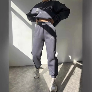 Dark gray two-piece tracksuit featuring a cropped sweatshirt and high waist joggers