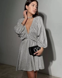 Detail of V-neck silver sequin party dress with lantern sleeves and draped waist texture