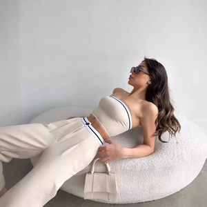 Detail of off-white two-piece set with striped tube top and high-waist wide-leg pants