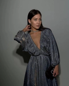 Detail of shimmering silver sequins on a deep V-neck evening gown with lantern sleeves