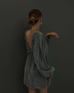 Detail of silver glitter dress featuring sexy open back and shiny metallic sequin texture