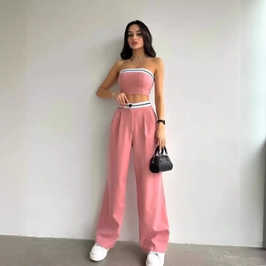 Pink two-piece set featuring a strapless crop top and high-waisted wide-leg trousers