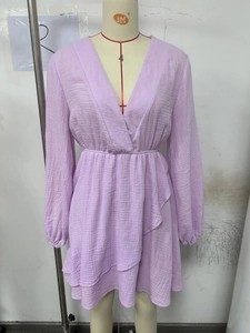 Detail view of V-neck lavender dress with elastic waist and layered ruffle skirt