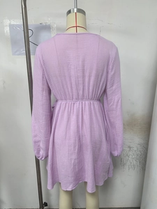 Detail of light purple long-sleeve dress featuring textured fabric and elastic waist