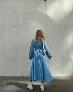 Detailed back view of a blue midi dress with cross-tie back and lantern sleeves