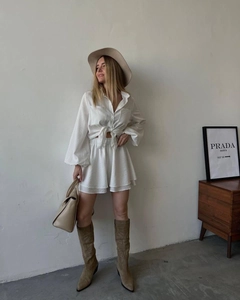 Detail of white two-piece set featuring long sleeve tie-up shirt and high waist shorts