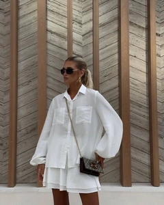 Close-up of white summer set with lantern sleeve button shirt and matching shorts