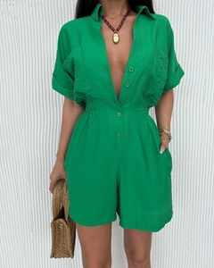 Detail of green short sleeve romper showing linen texture, lapel collar, and elastic waist
