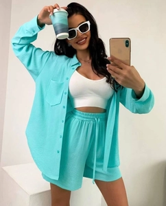 Detail showing mint green textured button-down shirt and white ribbed crop top set