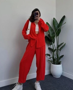 Detail of vibrant red textured fabric on the lapel shirt and wide-leg trousers set