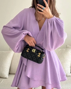 Detail of light purple V-neck dress featuring lantern sleeves and ruffled hem texture