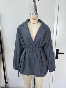 Detail view of winter lapel cotton coat with waist belt and elastic cuffs in dark grey