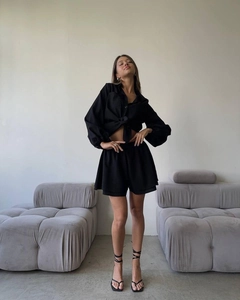 Detail view of black summer lounge set with long sleeve button-up shirt and high waist shorts
