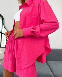 Detail of fuchsia crinkled fabric on a long sleeve shirt and matching drawstring shorts