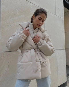Detailed view of winter padded coat with lapel collar and adjustable waist belt