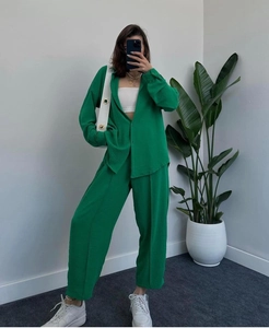 Detail of green long-sleeve loose shirt and high-waist straight pants set texture