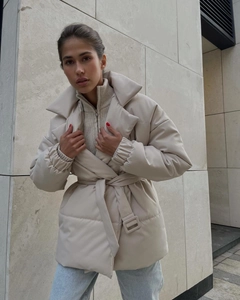 Detail of cream waist-tie padded jacket with wide collar and quilted warm construction