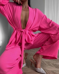 Detail of hot pink lounge set showing textured fabric and tie-front kimono cardigan design