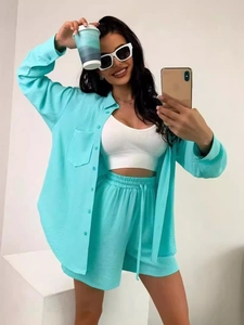 Bright mint green two-piece lounge set with long-sleeve button-up shirt and drawstring shorts