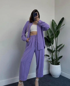 Detailed texture of lilac crinkled fabric on a casual button-down shirt and trouser set