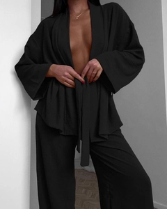 Detail view of black lounge set with belted wrap cardigan and wide-leg trousers