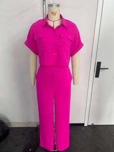 Detail of rose red two-piece suit with short sleeve shirt and wide leg pants set