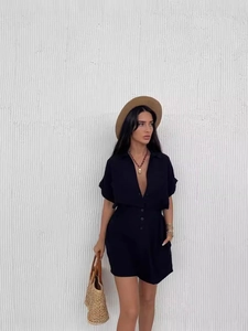 Women's black short sleeve romper with lapel V-neck and button detailing for summer