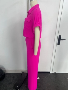Detail view of hot pink short sleeve button-up shirt and wide-leg trousers set